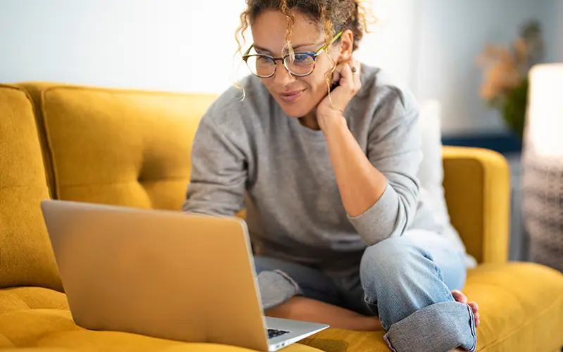 woman on laptop on couch